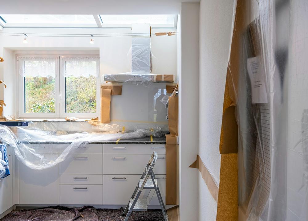 Kitchen being renovated, with units covered