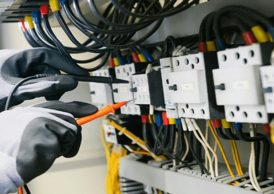 Electrician testing a fuse board
